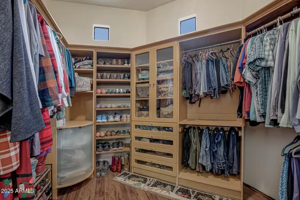 a bedroom with a bed a mirror and a large window