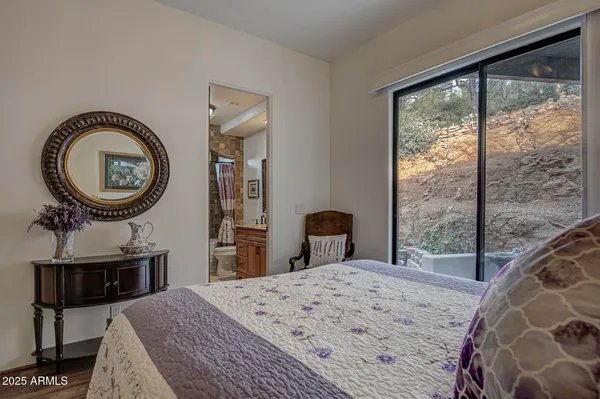 a bathroom with a granite countertop sink a toilet and shower