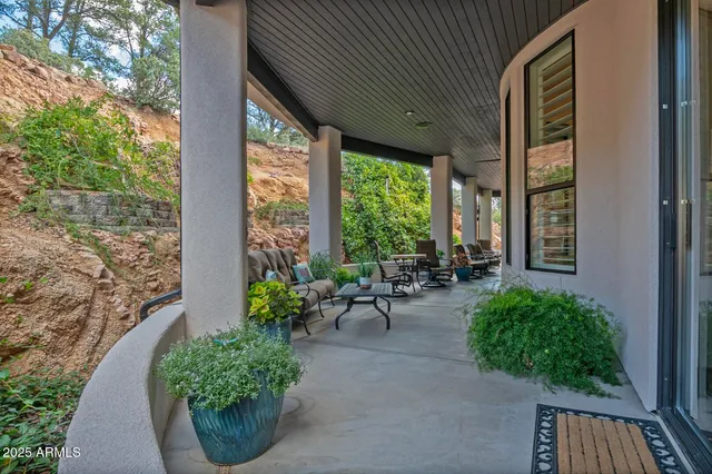 a view of a patio with table and chairs and potted plants