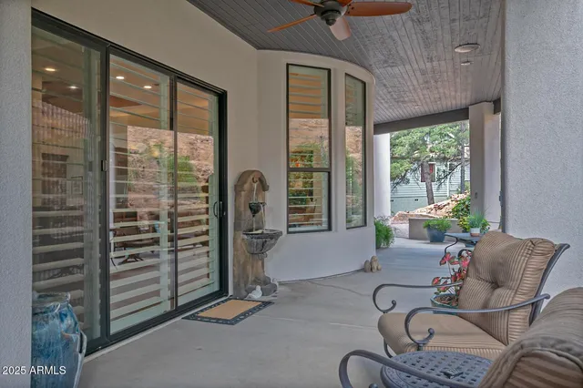 a living room with furniture and a floor to ceiling window