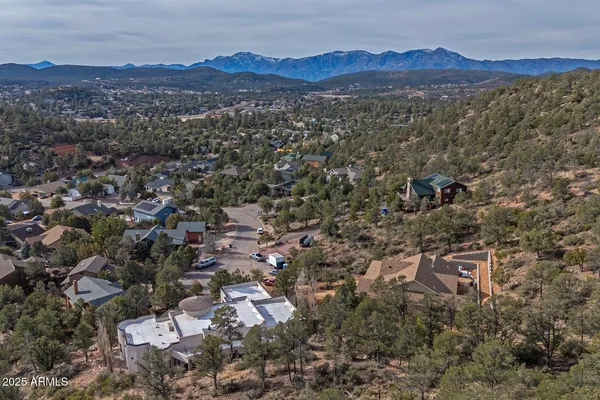an aerial view of residential house with an outdoor space and seating