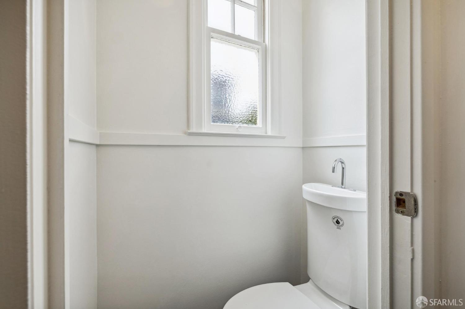 54 Upper Terrace San Francisco, CA 94117 - Photo 20 of 61 a bathroom with a toilet a sink a window and mirror