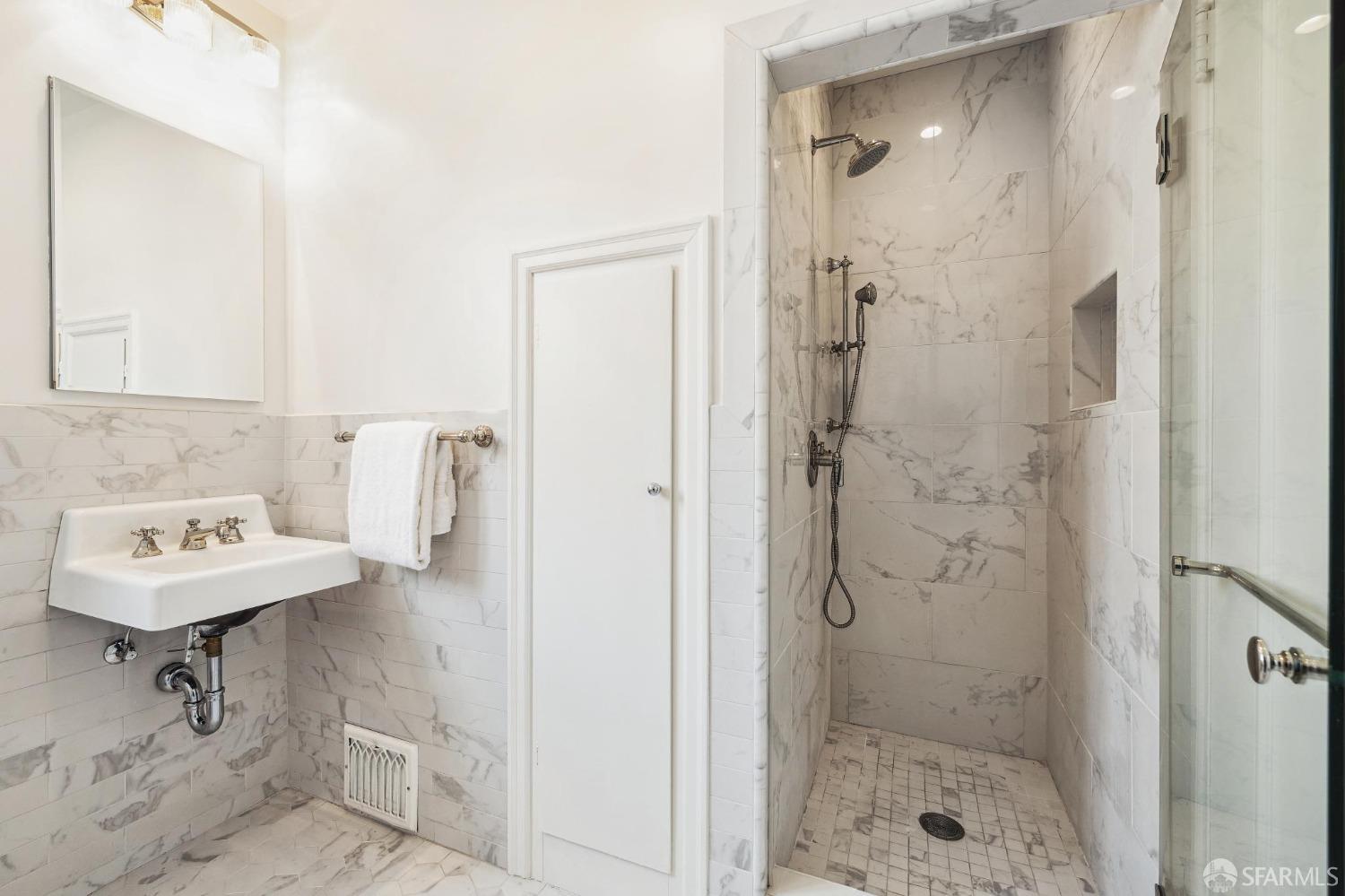 54 Upper Terrace San Francisco, CA 94117 - Photo 29 of 61 a bathroom with a sink a shower and a mirror