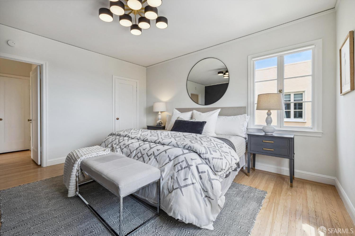 54 Upper Terrace San Francisco, CA 94117 - Photo 31 of 61 a bedroom with a bed and a chandelier