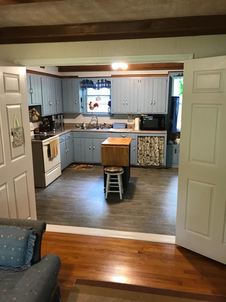 1490 Fall Creek Road Lebanon, TN 37090 - Photo 14 of 27 a kitchen with stainless steel appliances kitchen island granite countertop a stove a sink and a refrigerator