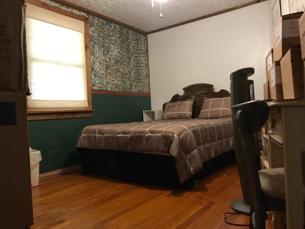 1490 Fall Creek Road Lebanon, TN 37090 - Photo 25 of 27 a bedroom with a bed and wooden floor