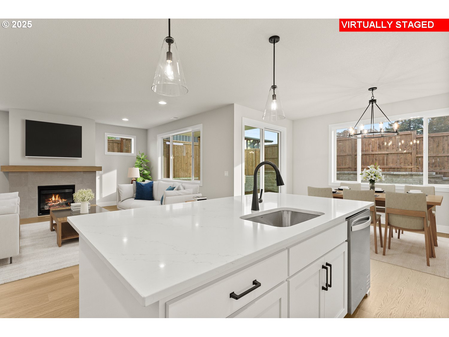 7212 Southwest Windflower Street Wilsonville, OR 97070 - Photo 11 of 28 a view of a kitchen with kitchen island a sink stainless steel appliances and living room view