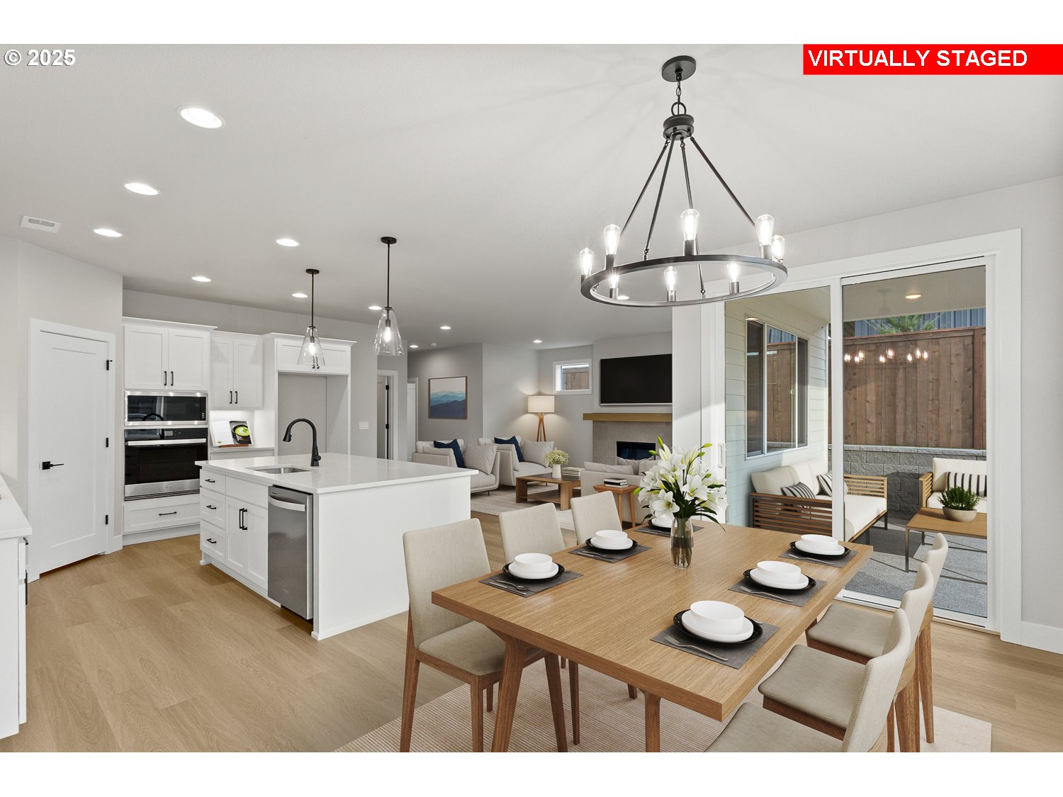 7212 Southwest Windflower Street Wilsonville, OR 97070 - Photo 13 of 28 a open dining room with stainless steel appliances kitchen island a table and chairs