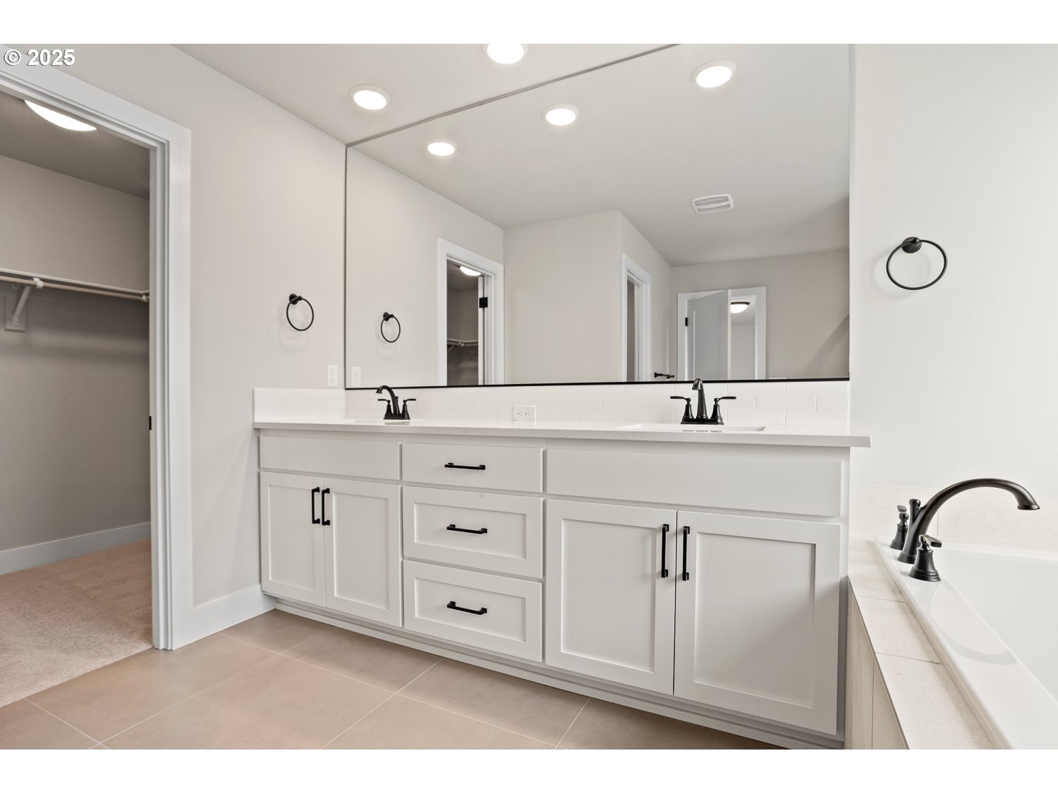 7212 Southwest Windflower Street Wilsonville, OR 97070 - Photo 17 of 28 a spacious bathroom with a double vanity sink a mirror a shower and vanity