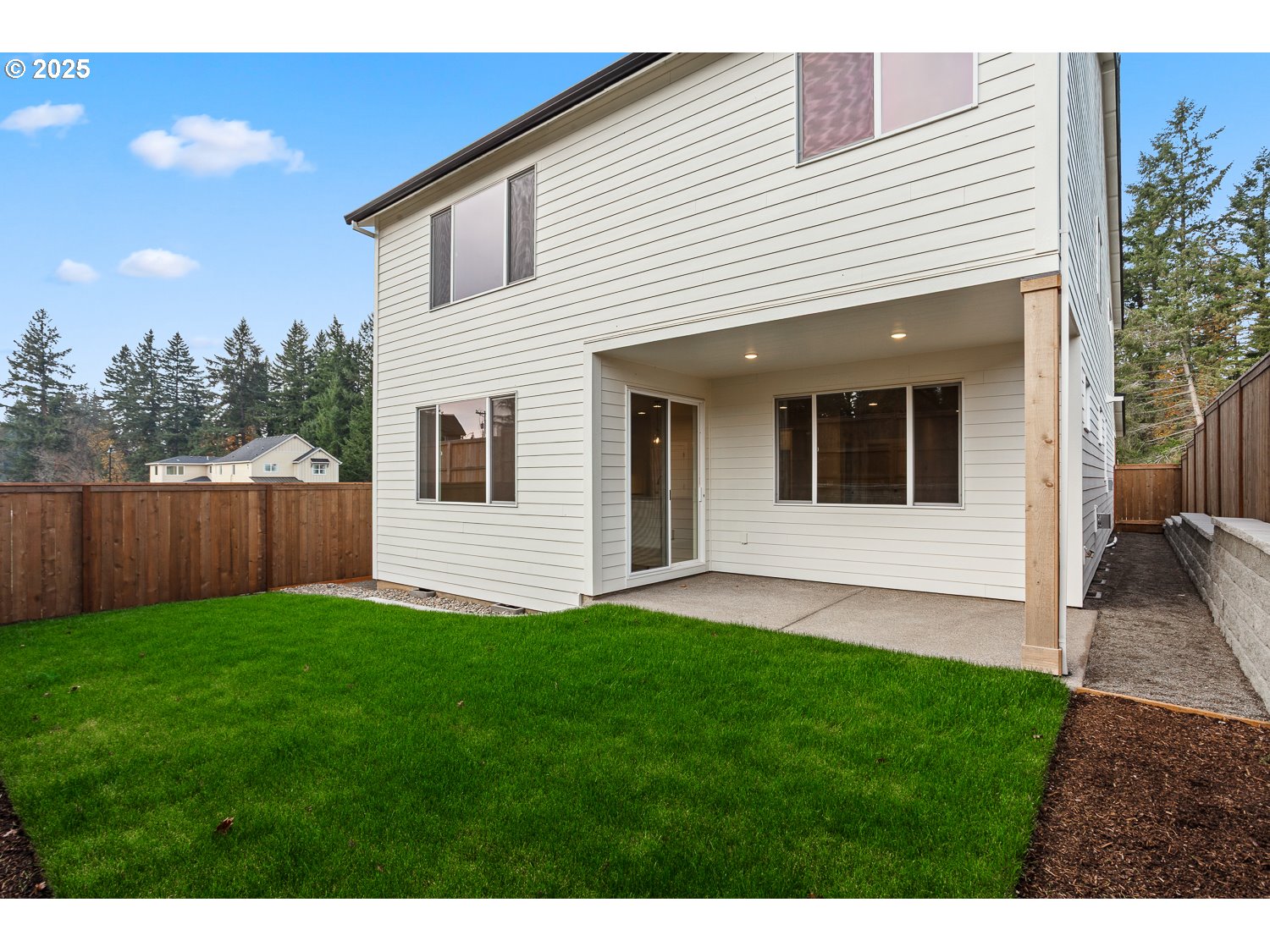 7212 Southwest Windflower Street Wilsonville, OR 97070 - Photo 26 of 28 a view of a backyard with plants and wooden fence
