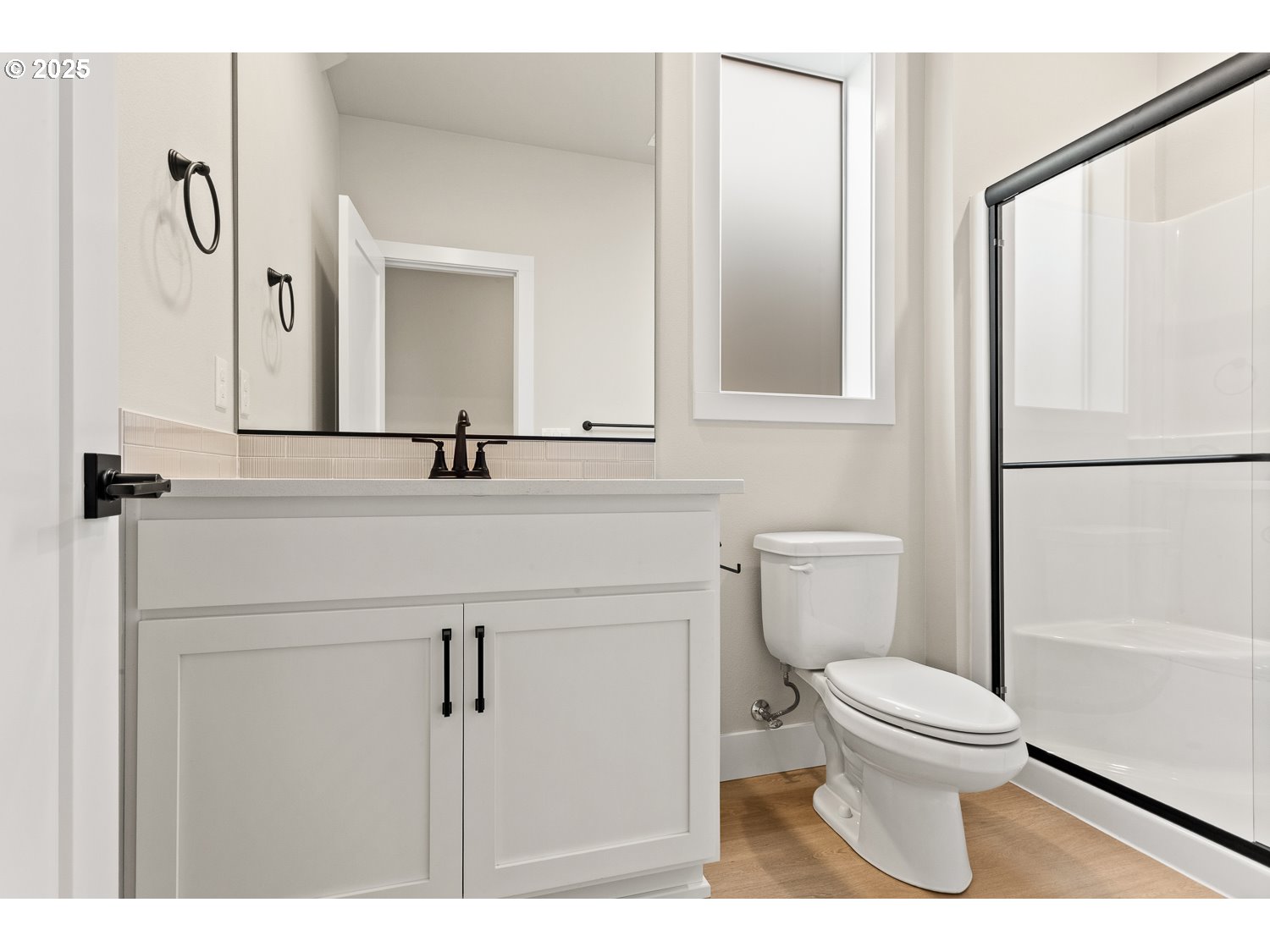 7212 Southwest Windflower Street Wilsonville, OR 97070 - Photo 8 of 28 a bathroom with a sink a toilet a mirror and shower