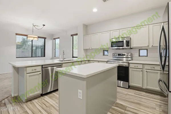 a kitchen with a sink stove and cabinets
