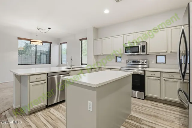 a kitchen with a sink stove and cabinets