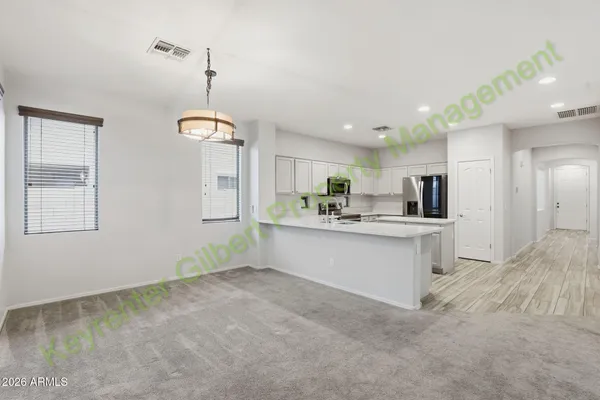 a view of a kitchen with refrigerator and a microwave