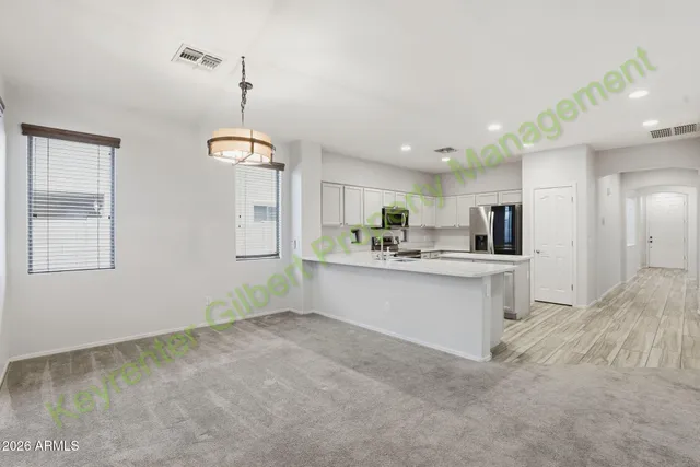 a view of a kitchen with refrigerator and a microwave