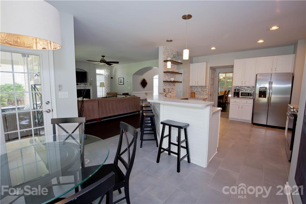 20200 Tailwind Lane Cornelius, NC 28031 - Photo 13 of 28 a large kitchen with a table and chairs