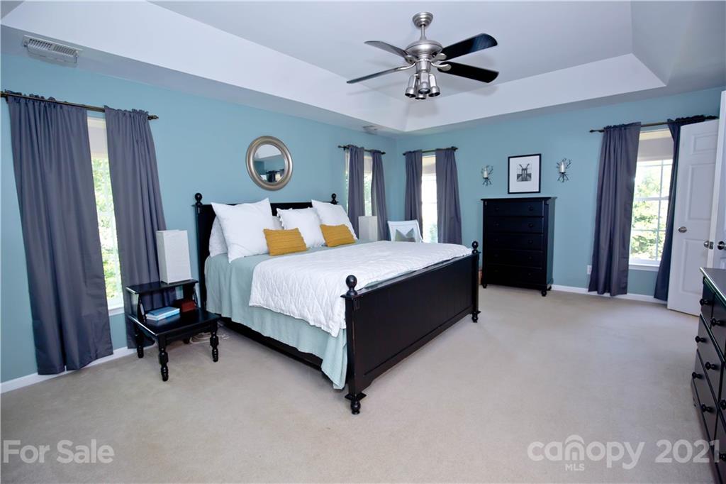 20200 Tailwind Lane Cornelius, NC 28031 - Photo 16 of 28 a bedroom with a bed dresser and a window