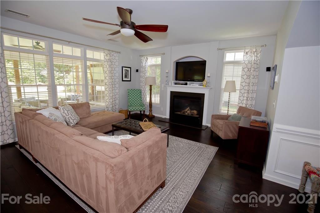 20200 Tailwind Lane Cornelius, NC 28031 - Photo 3 of 28 a living room with furniture a fireplace and a flat screen tv
