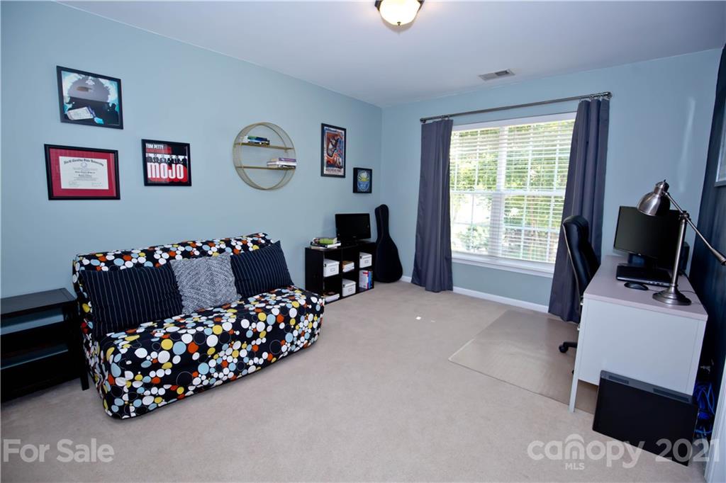 20200 Tailwind Lane Cornelius, NC 28031 - Photo 21 of 28 a bedroom with furniture and a window