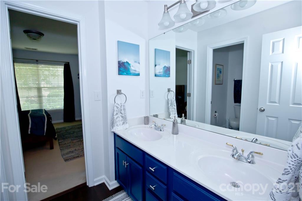 20200 Tailwind Lane Cornelius, NC 28031 - Photo 22 of 28 a en suite bathroom with a double vanity sink and a mirror