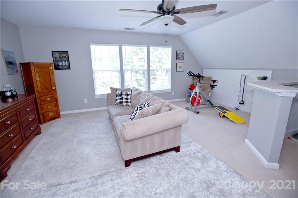 20200 Tailwind Lane Cornelius, NC 28031 - Photo 24 of 28 a living room with furniture and a flat screen tv