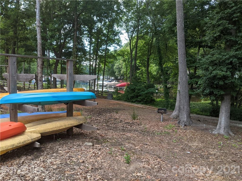 20200 Tailwind Lane Cornelius, NC 28031 - Photo 26 of 28 a backyard of a house with barbeque oven fire pit table and chairs