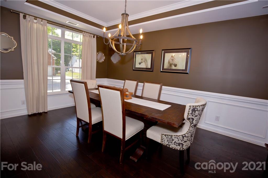 20200 Tailwind Lane Cornelius, NC 28031 - Photo 6 of 28 a view of a dining room with furniture wooden floor and chandelier