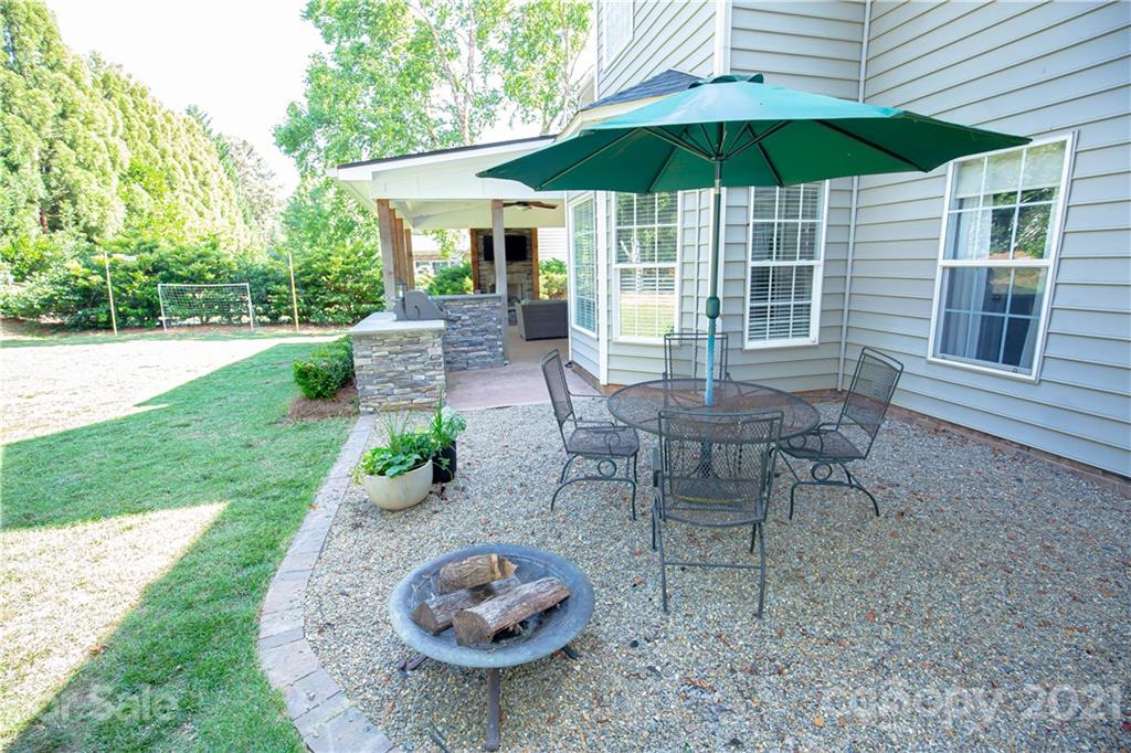 20200 Tailwind Lane Cornelius, NC 28031 - Photo 7 of 28 a view of a table and chairs under an umbrella