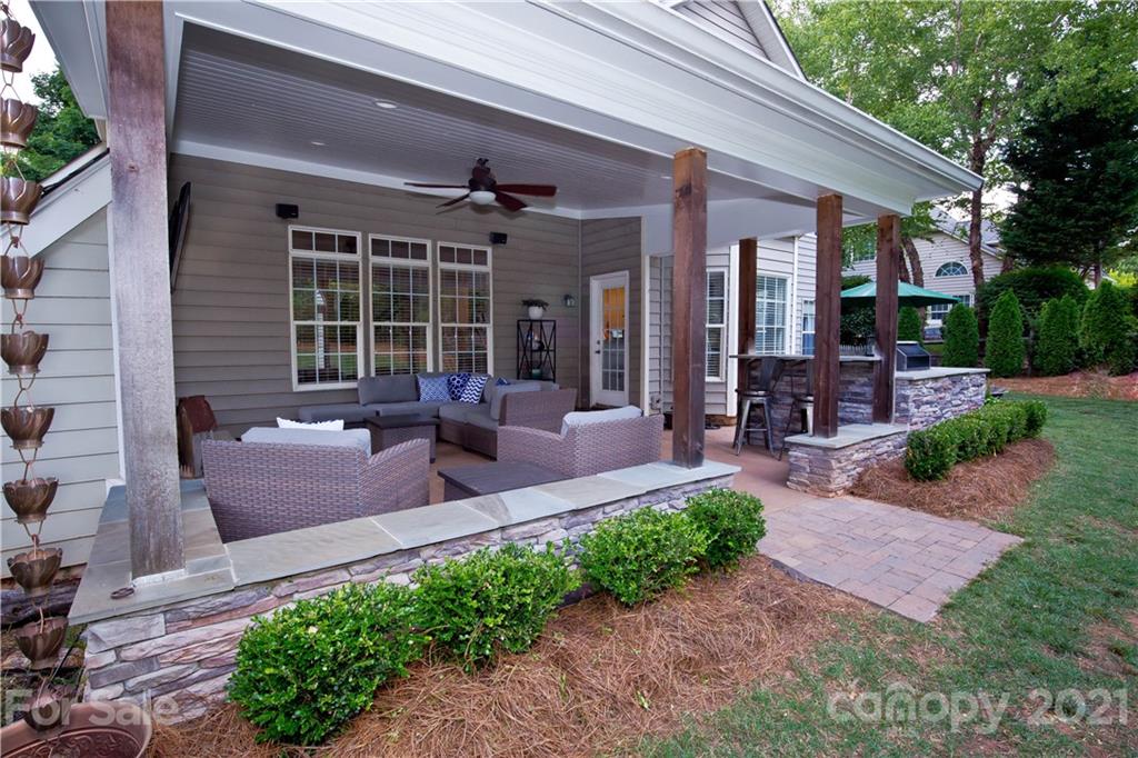 20200 Tailwind Lane Cornelius, NC 28031 - Photo 9 of 28 a view of a patio with couches chairs potted plants and floor to ceiling window and potted plants