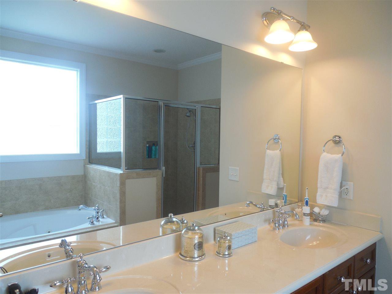 1618 Weatherford Circle Raleigh, NC 27604 - Photo 11 of 20 a bathroom with a double vanity sink and a mirror