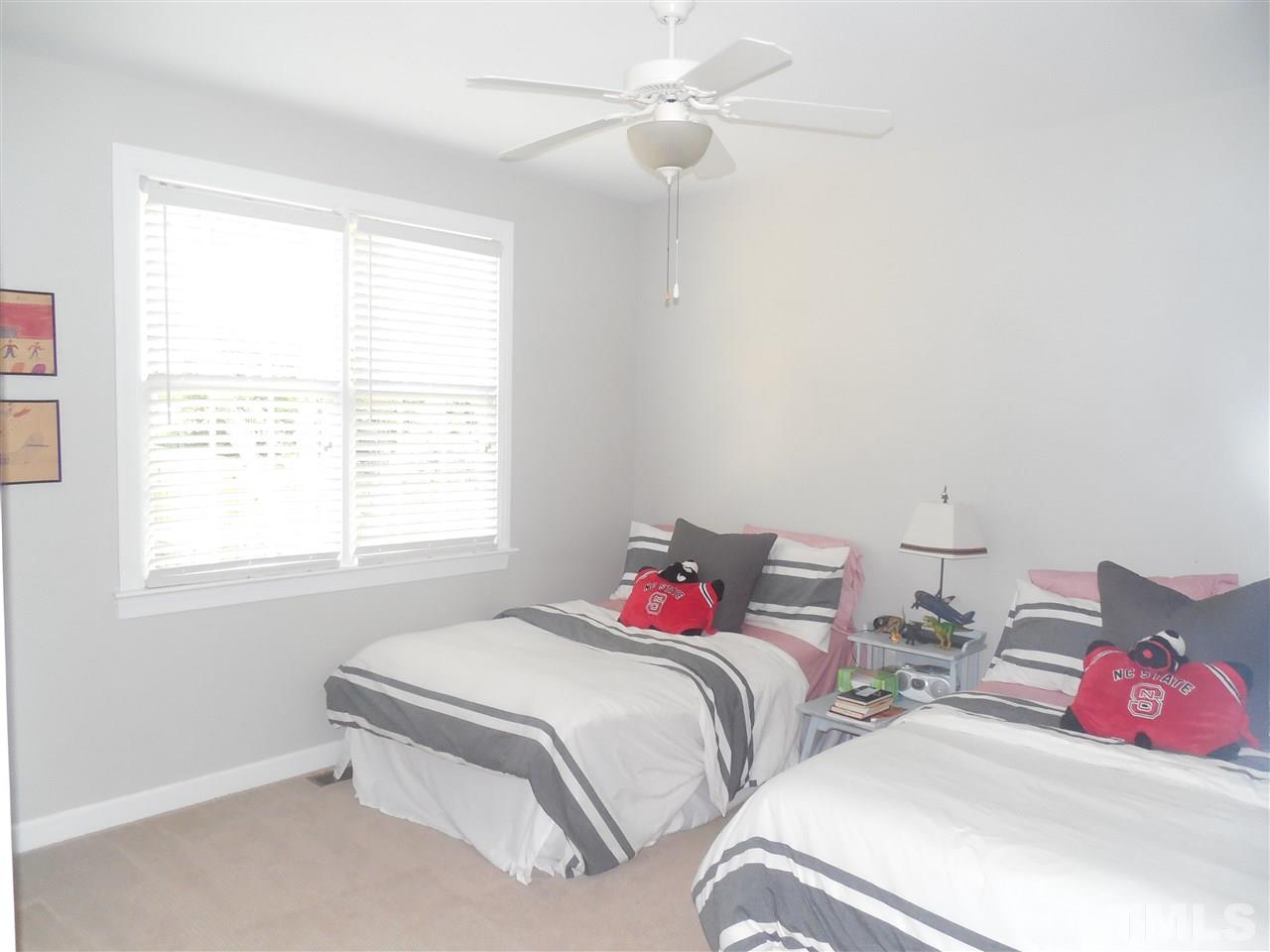 1618 Weatherford Circle Raleigh, NC 27604 - Photo 13 of 20 a bedroom with a bed and a chandelier