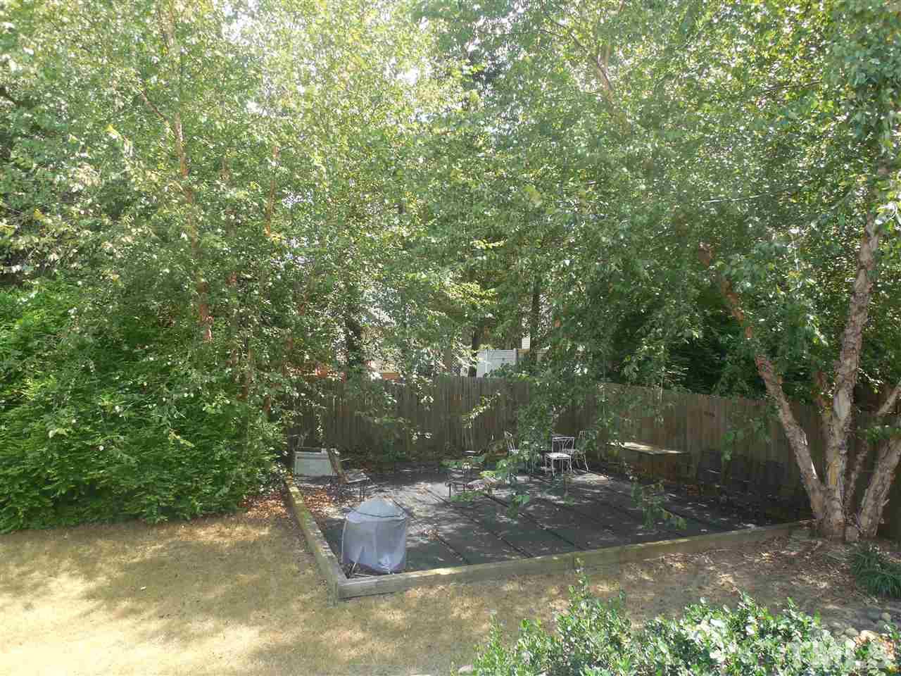 1618 Weatherford Circle Raleigh, NC 27604 - Photo 20 of 20 a view of a backyard with fountain plants and large trees