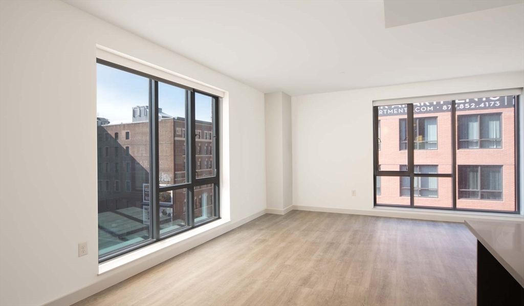 1 Canal Street, Unit 737 Boston, MA 02114 - Photo 2 of 12 an empty room with wooden floor and windows