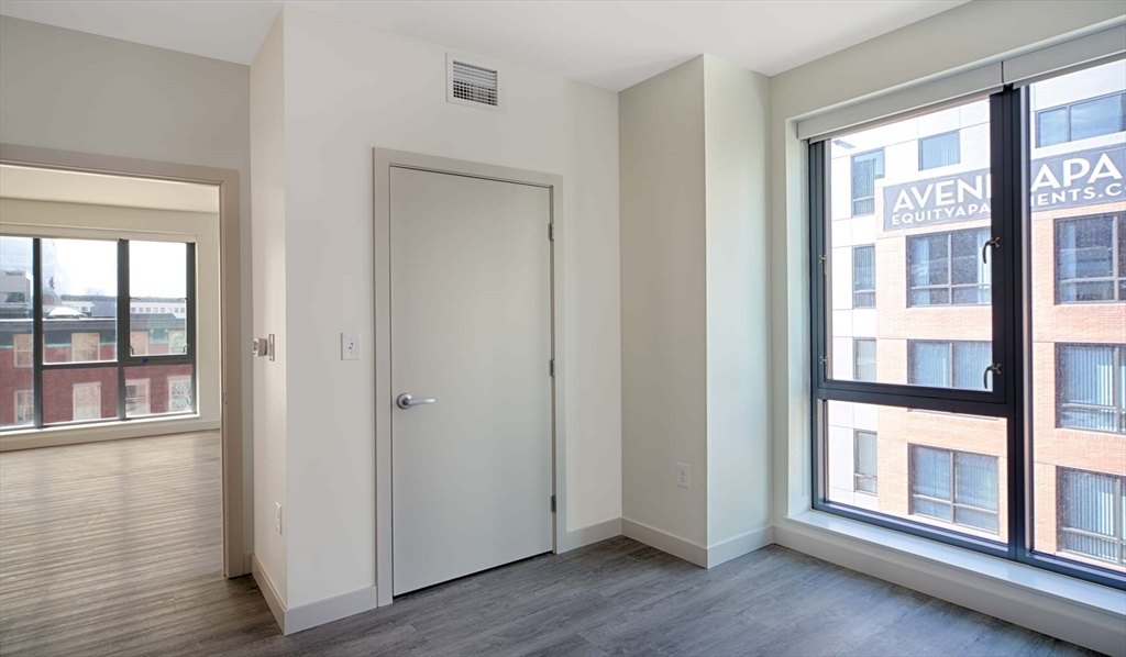 1 Canal Street, Unit 737 Boston, MA 02114 - Photo 3 of 12 a view of empty room with wooden floor and fan