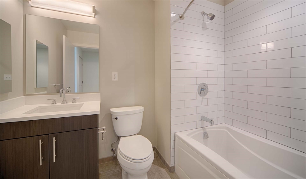 1 Canal Street, Unit 737 Boston, MA 02114 - Photo 4 of 12 a bathroom with a sink a toilet and shower