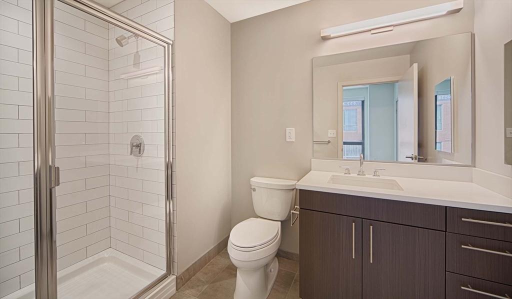 1 Canal Street, Unit 737 Boston, MA 02114 - Photo 6 of 12 a bathroom with a sink a toilet and shower