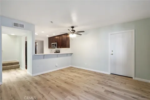 a view of a kitchen with microwave and cabinets