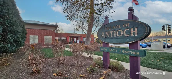 a view of a brick house with a sign on the side of the road