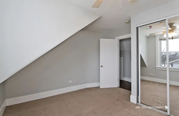 an empty room with windows and closet