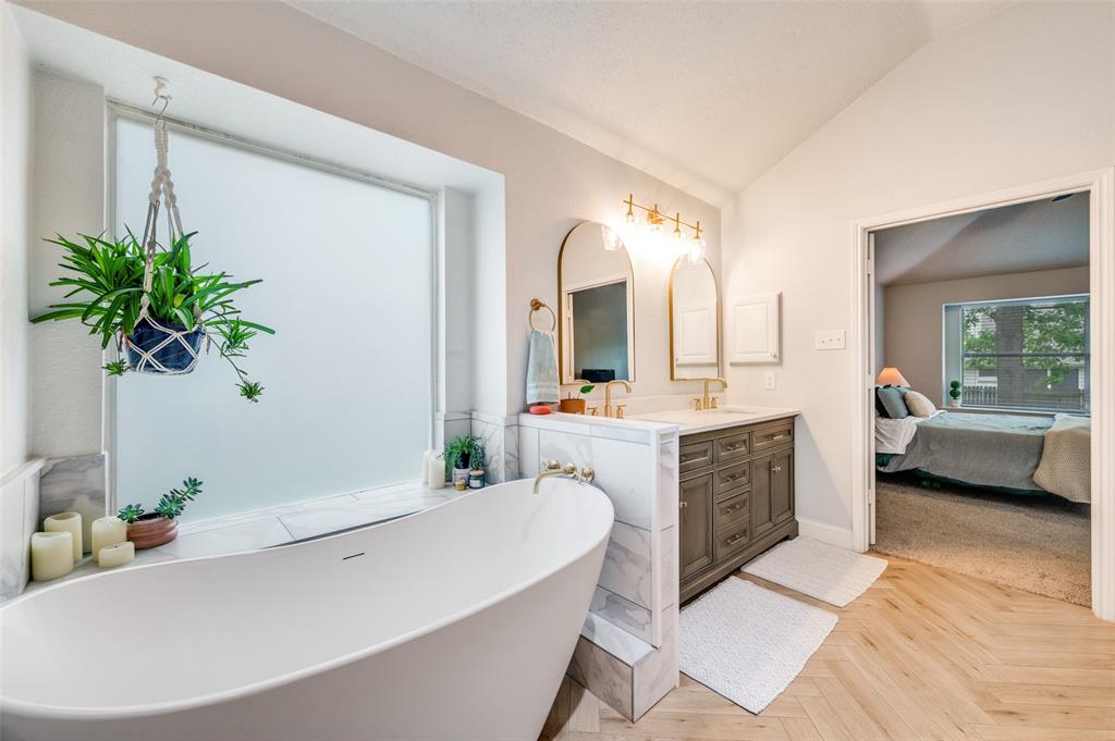 7306 Vista Ridge Lane Sachse, TX 75048 - Photo 15 of 23 a spacious bathroom with a double vanity sink a large mirror and a bathtub