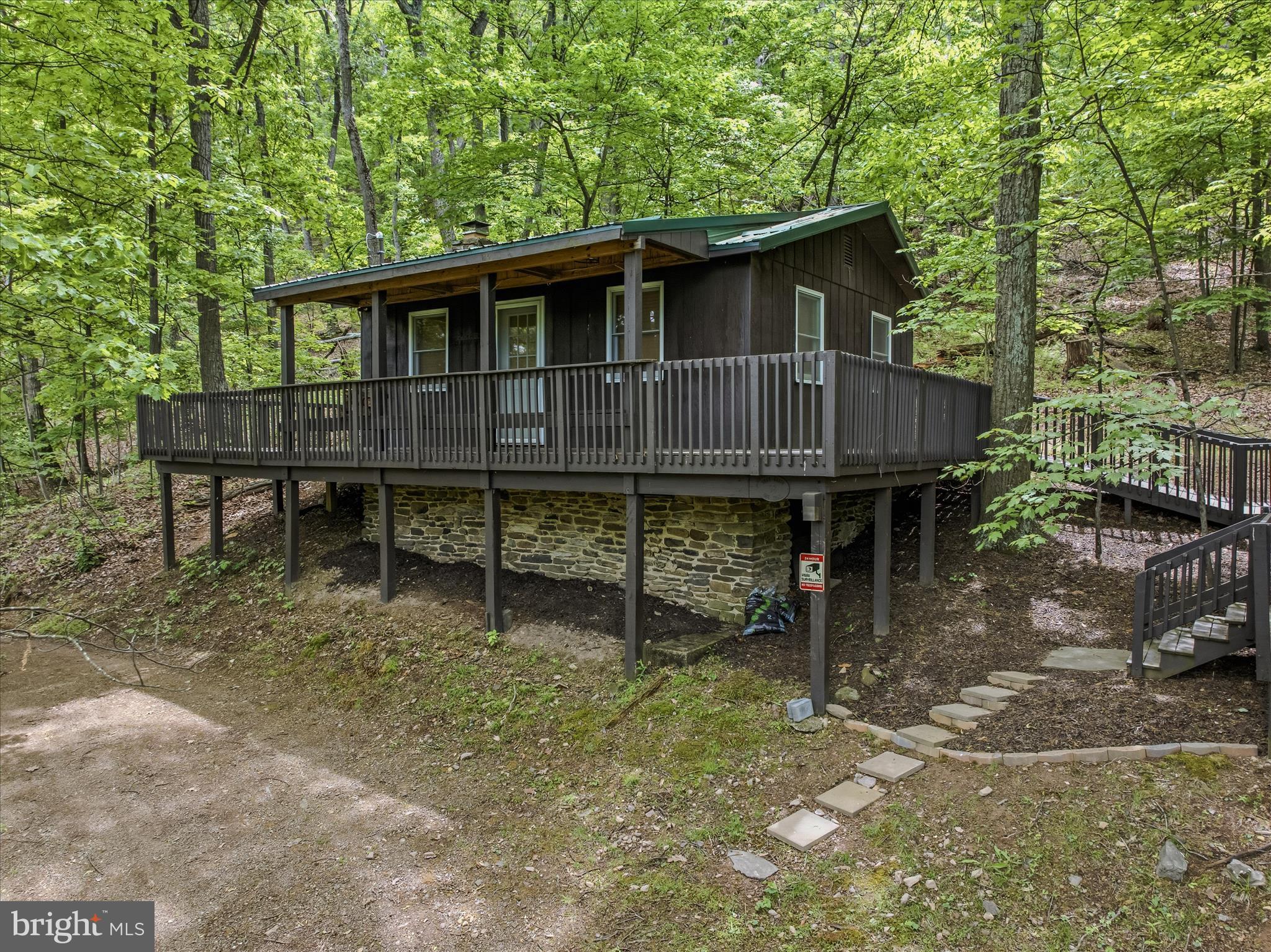 98 Ore Trail Berkeley Springs, WV 25411 - Photo 1 of 46 a backyard of a house with table and chairs