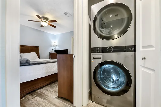 a view of a bedroom with washer and dryer