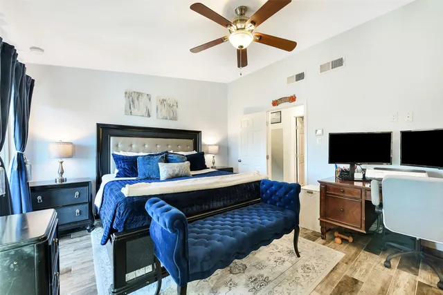 a bedroom with furniture and a flat screen tv