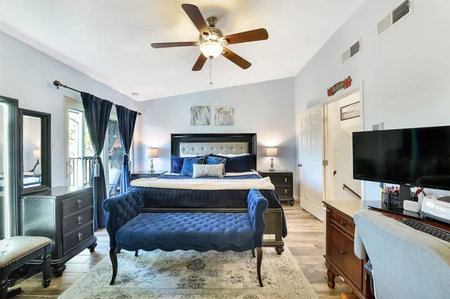 a bedroom with furniture and a flat screen tv