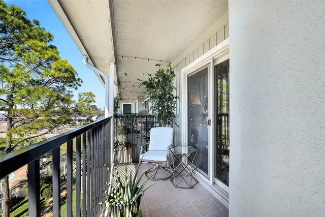 a view of a balcony with chair and table