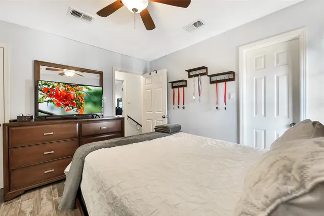 a bedroom with a bed and a chandelier