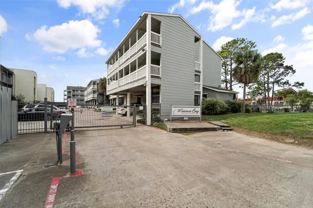 a view of a house with a yard and lake view