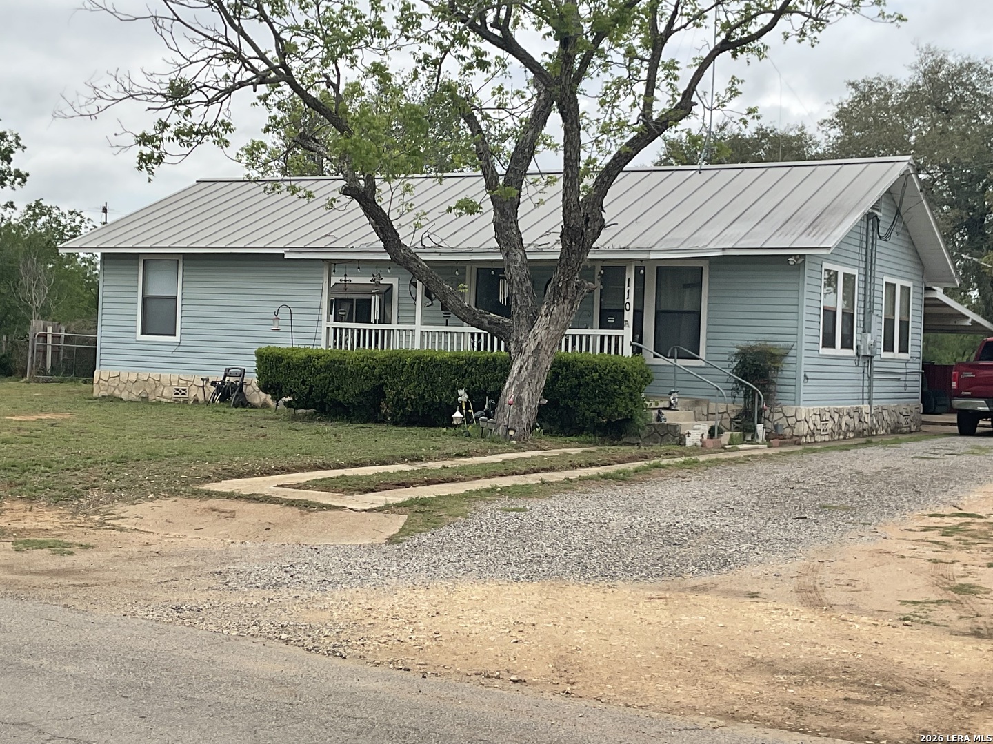 110 Renfro Drive Devine, TX 78016 - Photo 1 of 17 a front view of a house with a yard and garage