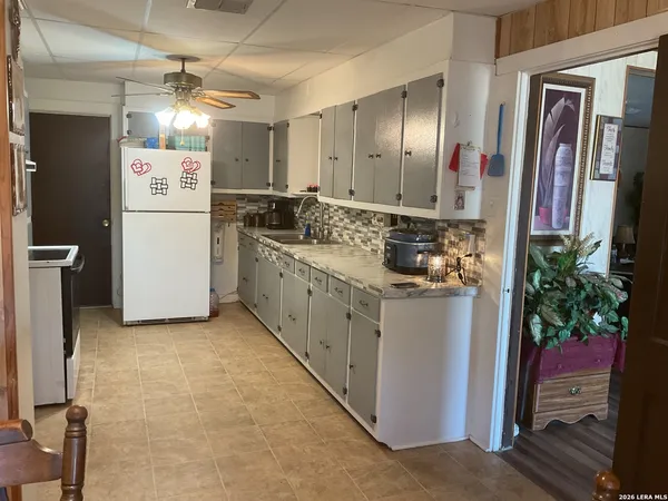 a kitchen with stainless steel appliances kitchen island granite countertop a refrigerator a stove a sink and dishwasher