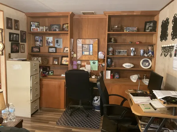 a view of a workspace with furniture and a bookshelf